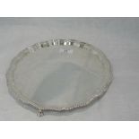 A silver salver of shaped circular form having gadrooned pie crust rim and trefoil ball and claw