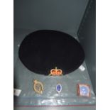 A beret bearing the Industrial Civil Defence Corp badge, a Royal Corp of Signals badge