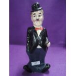 A plaster cast figural money box in the form of Charlie Chaplin