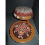 A small size golden oak foot stool with embroidered top and similar plaque