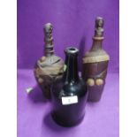 Two ceramic Calvados bottles with novelty stoppers and a vintage bottle