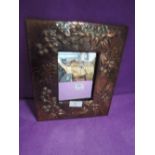 An arts and crafts style copper framed mirror