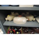 A selection of earthen ware salt glazed foot warmers