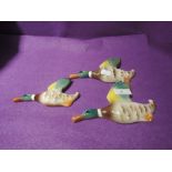 A set of ceramic wall mounted graduated ducks