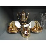 A part coffee service in gold gilt and white glaze