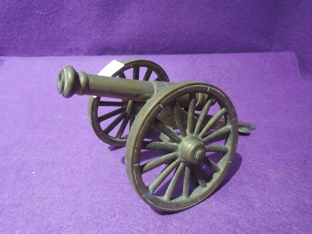 A brass model replica of a cannon