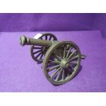 A brass model replica of a cannon