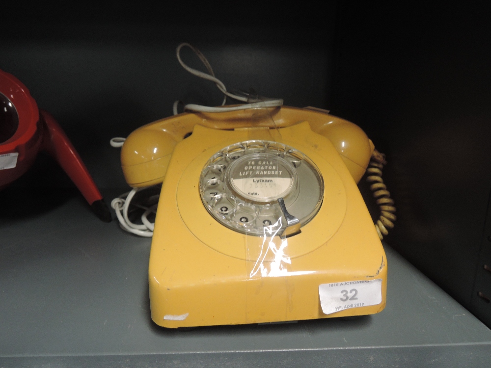 A vintage telephone by GPO with mustard colour body