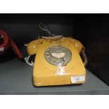 A vintage telephone by GPO with mustard colour body