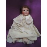 An early 20th century Heubach Koppelsdorf bisque headed doll having sleep eyes, open mouth with