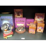 A shelf of Harry Potter collectables including Snow Globe, Secret Boxes etc, all boxed