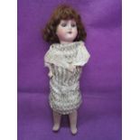 A German early 20th century bisque headed doll having sleep eyes, open mouth with five teeth