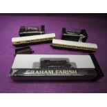 A Graham Farrish N gauge 0-6-0 tank locomotive along with two carriages and three wagons, some