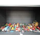 A shelf of playworn diecasts including Corgi, Matchbo, Lesney and similar