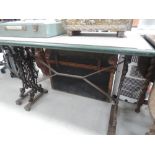 A vintage metal frame garden table with later top