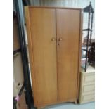 A vintage golden oak wardrobe, labelled Austinsuite