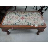 A traditional stained frame footstool with cabriole legs