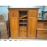 A Victorian Satinwood triple wardrobe having central mirrored door drawer section