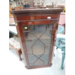 A mahogany corner display wall cabinet