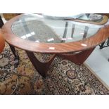 A vintage sapele or teak glass top coffee table