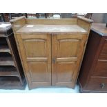 A late 19th/early 20th Century oak side cabinet in the Arts and Crafts style