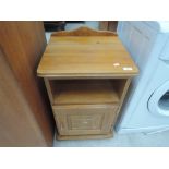 A modern pine bedside cabinet