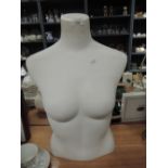 A shop display manikin torso