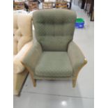 An Ercol style beech frame easy chair, with green upholstery