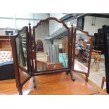 A modern mahogany triptych toilet mirror