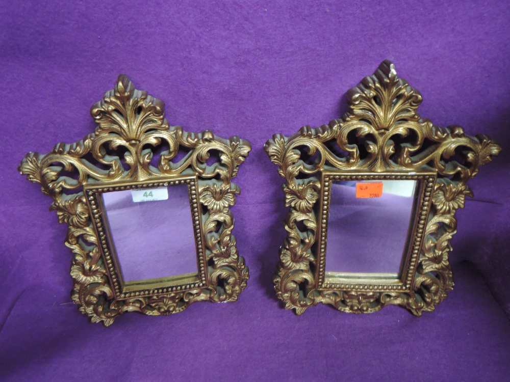 A pair of modern gilt plaster hall mirrors