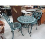 A modern cast painted garden table and two chairs