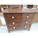 A stained frame two over two bedroom chest