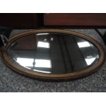 A gilt frame oval wall mirror