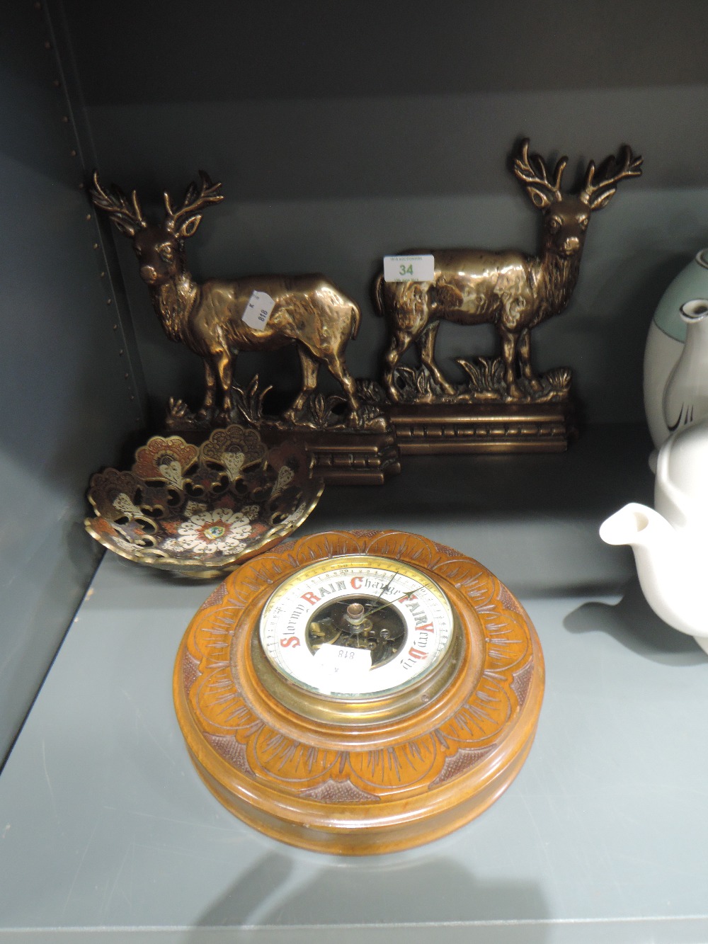 An Aneroid barometer, Indian style brass dish and pair of brass door stops modelled as stags