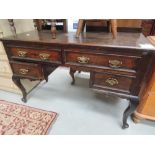 A Victorian oak dressing table having ledge back and cabriole legs