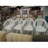 Four plastic garden chairs