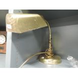 A brass desk top light with goose neck