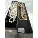 A selection of costume jewellery including Trifari bracelet, white metal filligree bracelet,