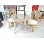 A cane conservatory set of table and 2 chairs