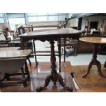 A 19th century mahogany pedestal table having square fret apron top on bulbous column and triple