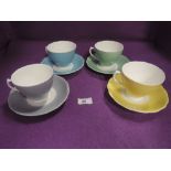A selection of harlequin tea cups and saucers
