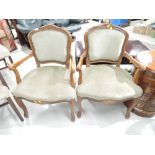 A pair of French style low seat armchairs