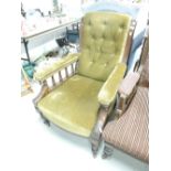 A Victorian mahogany frame salon armchair having spindle supports and later moss green upholstery,