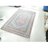 A traditional Persian style rug in blue and pink