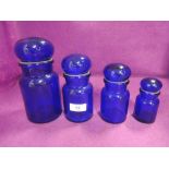 A set of graduated Belgian blue glass jars