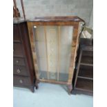 A mid 20th Century walnut display cabinet