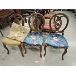 A set of three 19th century stained frame dining chairs having oval scroll lattice backs with