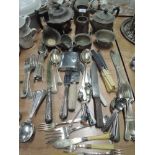 A selection of cutlery flatware and kitchen utensils