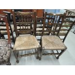 A pair of early 20th century oak vernacular chairs in the period Lancashire spindle back design