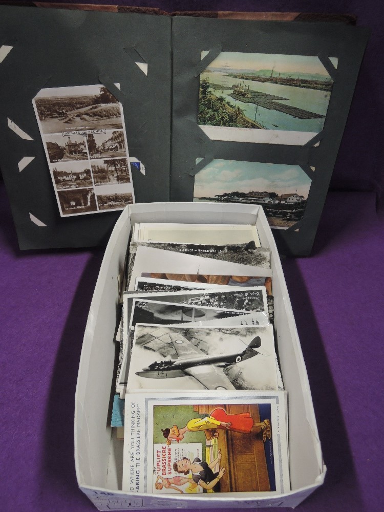 An album and box of vintage postcards